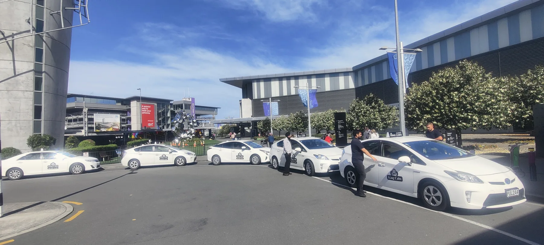 Taxi Christchurch – King Cabs 8 Genuine King Cabs taxi fleet assembled at Christchurch Airport on a clear day
