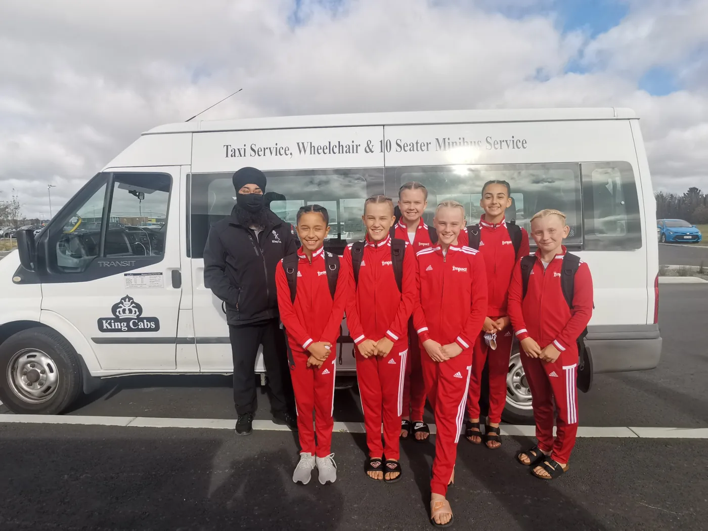 King Cabs 10-seat maxi taxi with transported junior sports group and driver