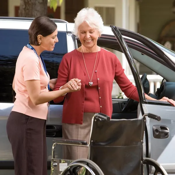 Taxi Christchurch – King Cabs 7 Companion assisting an older passenger with mobility beside a car